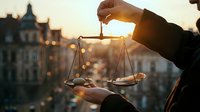 Professional hands holding golden scales of justice at sunset with urban courthouse background symbolizing legal balance and fairness in law practice.