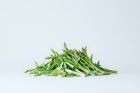 Fresh green string beans sliced lengthwise into thin strips on white background, raw organic produce for healthy cooking and food preparation.