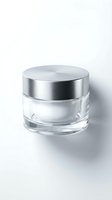 Empty glass cosmetic jar with silver metal lid isolated on white background for skincare product packaging and beauty brand mockups.