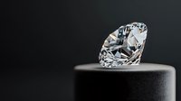 Brilliant cut diamond solitaire on dark minimalist platform against black background showcases luxury jewelry craftsmanship and precious stone brilliance.