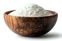 White flour in decorative wooden bowl with distinctive grain pattern and natural texture, isolated on white background for culinary and baking concepts.