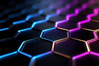 Abstract hexagonal background with neon blue and pink glowing edges on black surface creating futuristic technological pattern with depth of field effect.