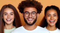 Three diverse young adults smiling at camera against warm orange background. Mixed ethnicity group portrait for lifestyle marketing campaigns.