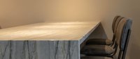 Modern marble kitchen island with wooden countertop and bar stools in contemporary interior design for luxury home decor and architectural visualization.