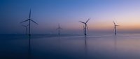 Offshore wind turbines generating renewable energy at twilight with calm ocean reflections and gradient sky colors for sustainable power concepts.