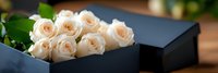 Elegant cream roses arranged in luxury black gift box with ribbon, romantic floral arrangement for special occasions, weddings, anniversaries and celebrations.