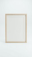 Empty wooden picture frame with white mat on light gray wall ready for artwork display and home decor projects.