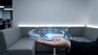 Businessman holding glowing futuristic hologram with digital interface icons, representing innovation, technology, and data management concepts.