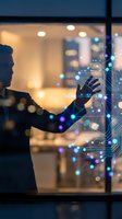 Businessman in suit interacting with glowing digital network interface, futuristic technology concept with neon circuit nodes in dark office.