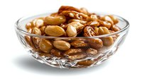Roasted peanuts in crystal glass bowl on white background, showcasing golden brown color and crunchy texture for food photography and culinary design.