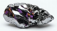 Raw silicon carbide mineral specimen displaying metallic luster with iridescent purple and rainbow reflections on crystalline surface for geology education.
