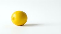 Fresh yellow lemon fruit isolated on clean white background for healthy cooking and citrus nutrition concepts.