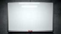 Empty whiteboard with silver frame mounted on dark textured wall ready for presentations, meetings, brainstorming sessions and educational content.