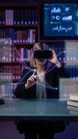 Professional businesswoman using VR headset with holographic data displays and digital interfaces in modern office library environment for immersive technology experience.