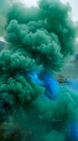Vibrant green and blue smoke clouds swirling in water creating abstract fluid motion for creative design projects and artistic backgrounds.
