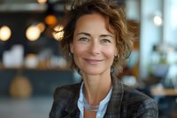 Confident mature businesswoman with natural smile in modern office setting, perfect for corporate marketing, leadership, and professional success concepts.