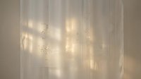 Soft warm light filtering through sheer white curtains with delicate string lights creating an ethereal, dreamy atmosphere. Perfect for home decor, wellness, and lifestyle design projects.