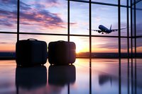 Luggage silhouettes at airport terminal with airplane flying in dramatic sunset sky, reflecting on glossy floor.