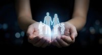 Hands holding glowing family silhouettes representing protection, care and insurance coverage for loved ones in dark background.
