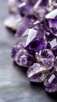 Purple amethyst crystals and gemstones scattered on dark surface with shallow depth of field for luxury jewelry and healing stone concepts.