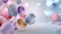 Abstract colorful spheres floating in soft focus background with pink, purple, gold, and gray bubbles creating dreamy atmospheric composition.