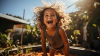 Joyful young mixed race girl with curly hair laughing outdoors in garden during golden hour sunlight, expressing pure happiness and carefree childhood moments.