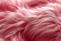 Soft pink faux fur texture background with fluffy fibers and delicate waves creating luxurious textile surface pattern for fashion and interior design projects.