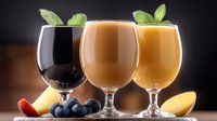 Fresh fruit smoothies in elegant glasses garnished with mint leaves and berries, healthy drinks lineup on wooden surface against dark background.