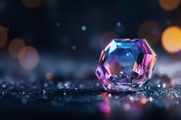 Sparkling crystal gem with rainbow reflections on dark surface with bokeh lights background for luxury jewelry and precious stone concepts.