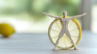 Athletic male figure stretching with arms wide open against fresh lemon slice background, representing healthy lifestyle and vitamin C benefits for wellness.
