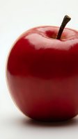 Fresh red apple with stem isolated on white background, suitable for food, nutrition, health and wellness design projects.