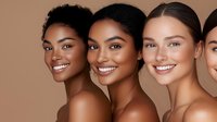 Diverse group of smiling women with different skin tones and natural makeup showing beauty in diversity, glowing healthy skin and confident expressions.