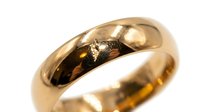Polished gold band ring with smooth, rounded dome profile and lustrous finish, suitable for wedding, engagement, or fashion jewelry design projects.