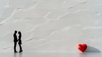 Minimalist romantic scene with couple silhouette facing each other and red geometric heart on white textured background casting soft shadow.