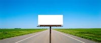 Empty white billboard on rural highway with green fields and clear blue sky for outdoor advertising campaigns and marketing messages.