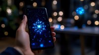 Glowing blue digital snowflake on smartphone screen against blurred bokeh lights background creates magical winter atmosphere for seasonal designs.
