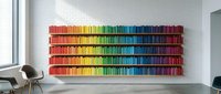 Rainbow colored books arranged in gradient spectrum on white wall shelves creating vibrant library display for modern interior design and organization.