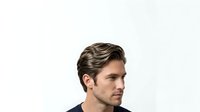 Young adult male with light brown hair and facial hair, wearing dark navy clothing, isolated on white background suitable for corporate, business, and professional design projects.