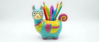 Colorful llama pencil holder with vibrant rainbow markers and colored pencils, isolated on white background, perfect for desk organization, classroom supplies, and creative workspace decoration.