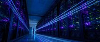 Modern data center with rows of illuminated server racks emitting blue and purple light, representing cloud computing, network infrastructure, and digital technology for enterprise solutions.