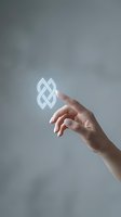 Hand reaching toward glowing geometric infinity symbol representing connection, unity and endless possibilities in modern minimalist style.