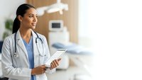 Young Hispanic female doctor with stethoscope holding tablet in modern hospital room, smiling confidently while providing healthcare services.