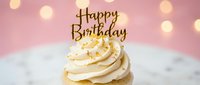 Vanilla cupcake with swirled cream frosting and golden Happy Birthday topper on pink bokeh background, perfect for celebration and party concepts.