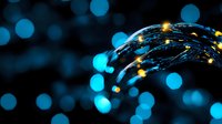 Glowing fiber optic cables with blue bokeh background create modern technology concept. Network and digital communication design element for business presentations.
