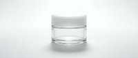 Clear glass cosmetic jar with white cap isolated on white background, ready for skincare product packaging and design mockups.