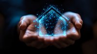 Glowing blue house silhouette floating above cupped hands against dark background, magical sparkles and particles creating ethereal real estate concept.