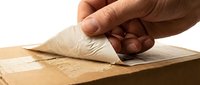 Hand opening cardboard box flap, unboxing delivery package on white background, logistics and shipping concept.