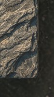 Ancient stone surface with weathered texture and natural erosion patterns creating organic shapes and shadows on rough carved block material.