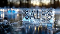 Frozen word SALES carved in ice block with natural bokeh lights background, winter seasonal promotion concept for marketing and advertising.