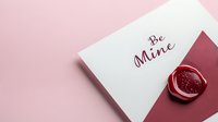 Romantic love letter with "Be Mine" text and red wax seal on pink and burgundy background, minimalist Valentine's Day greeting card design.